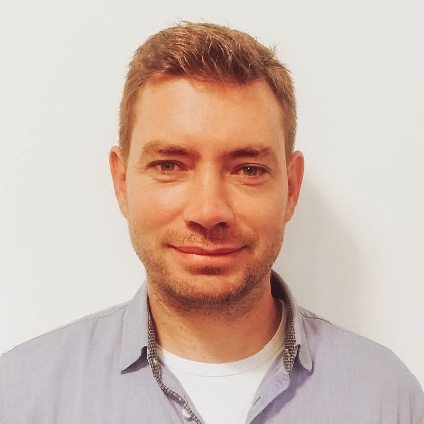 Smiling person in a light blue shirt