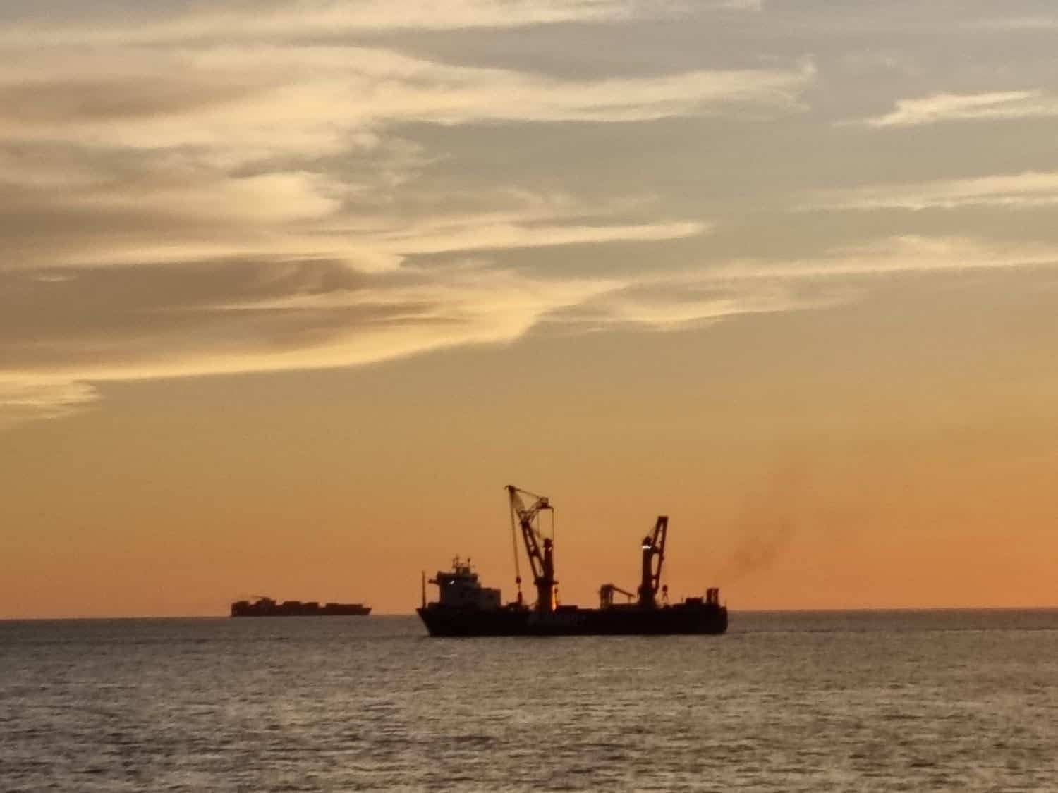 Ships at sea during sunset