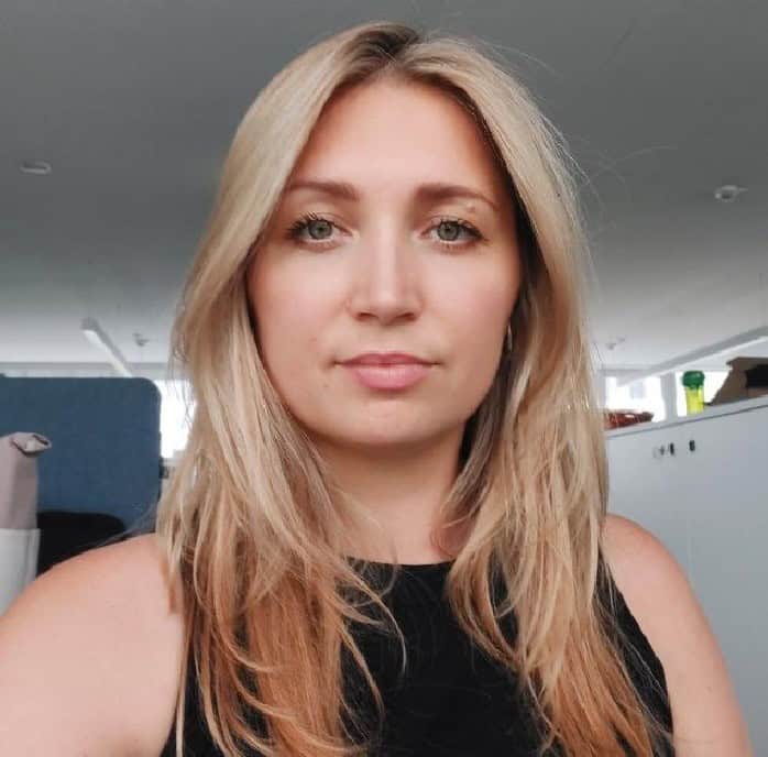 Blonde woman taking an indoor selfie
